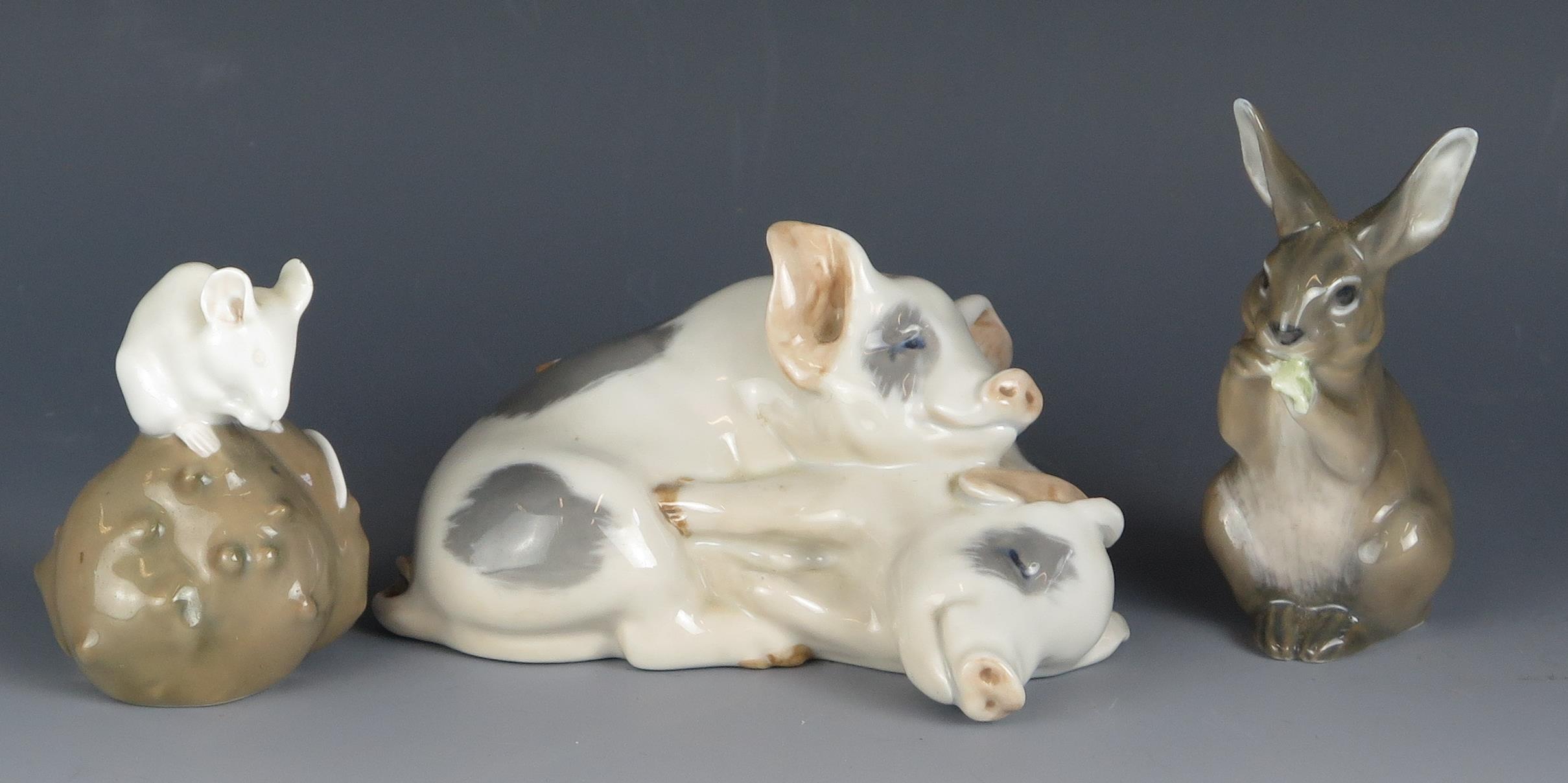 A Royal Copenhagen model of two piglets lying side by side, 11,5cm wide, together with a model of