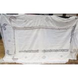 A linen tablecloth, with cut-work decoration and crochet edged borders, 260 x 152cm.
