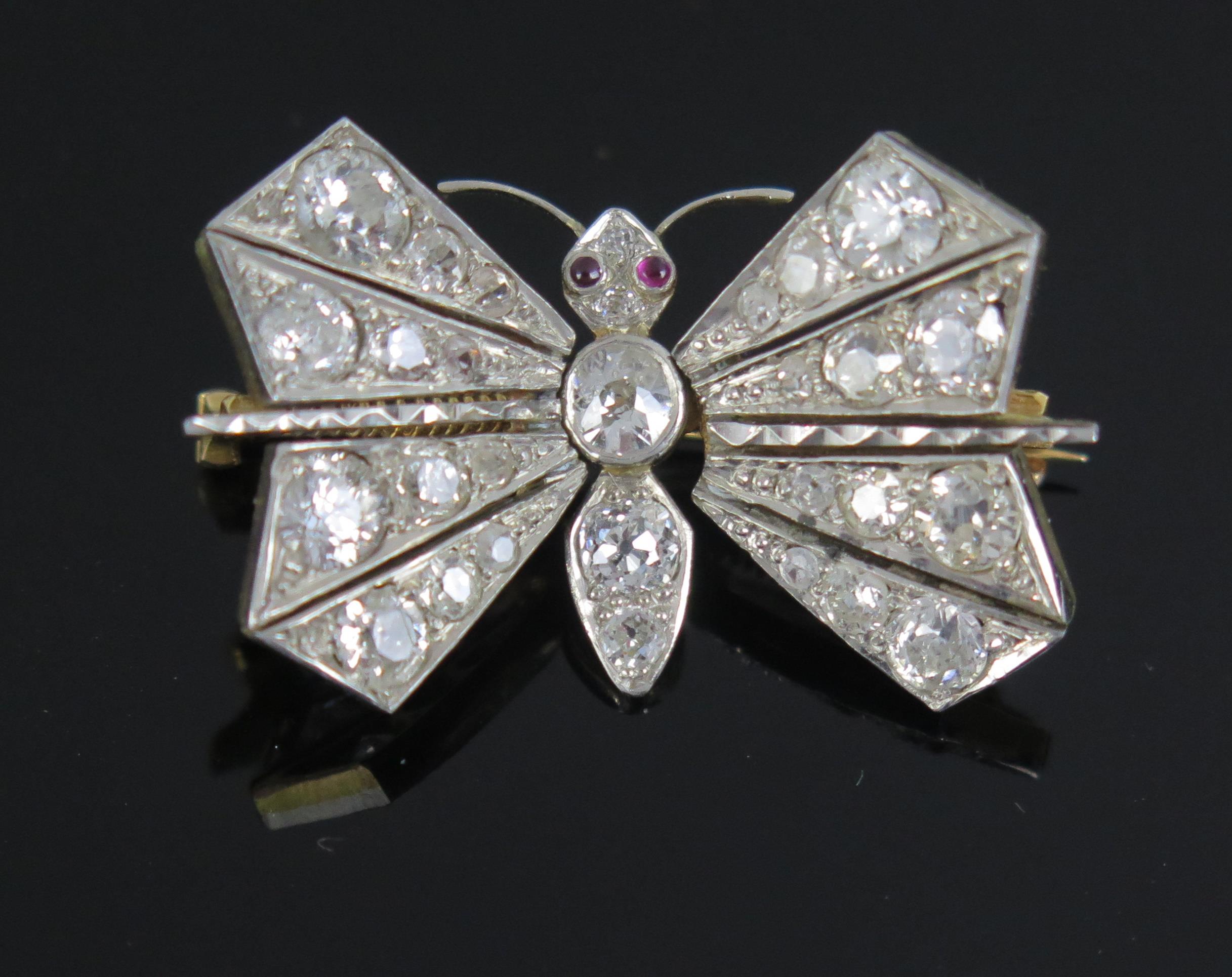 A Diamond Set En Tremblant Butterfly Brooch with spring mounted wings, set with old round cuts and