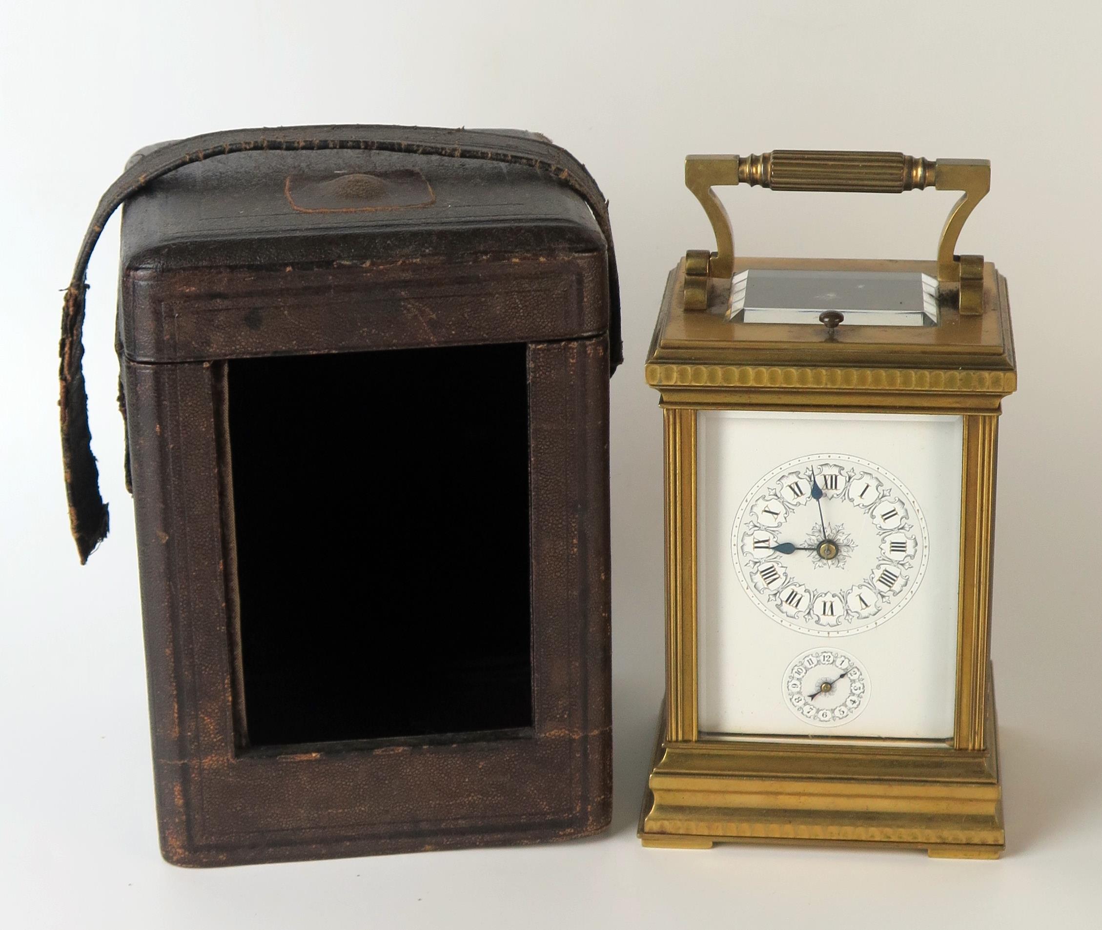 A late 19th century French brass carriage clock, with 8cm Roman dial with subsidiary alarm dial, the