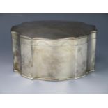 A white metal casket, of cartouche-shaped outline, with shallow domed hinged lid, and gadrooned rim,