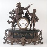 A late 19th century bronzed metal figural mantel clock, the 8cm enamelled Roman dial, contained in a