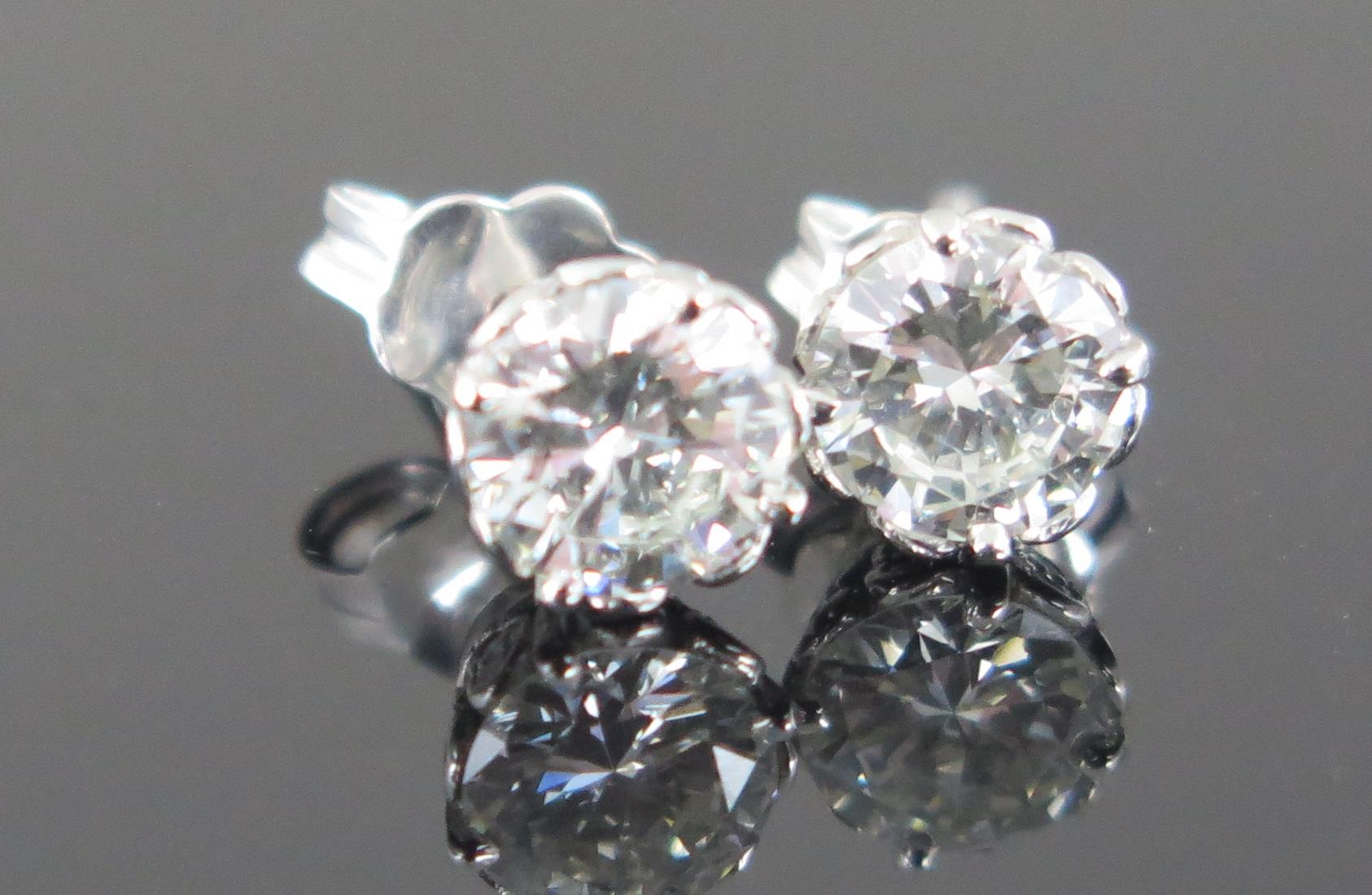 A Pair of Diamond Stud Earrings, 18ct white gold clips stamped 750, EDW 1.5ct, 2.8g