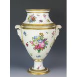 A continental porcelain caviar holder, of ovoid form, with floral spray decoration, with female mask