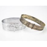 A White Metal Bangle, together with another chrome plated, (2).
