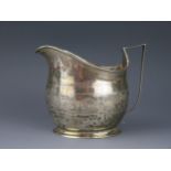 A George III silver cream jug, maker RF, monogrammed, of barge-shaped outline with banded foliate