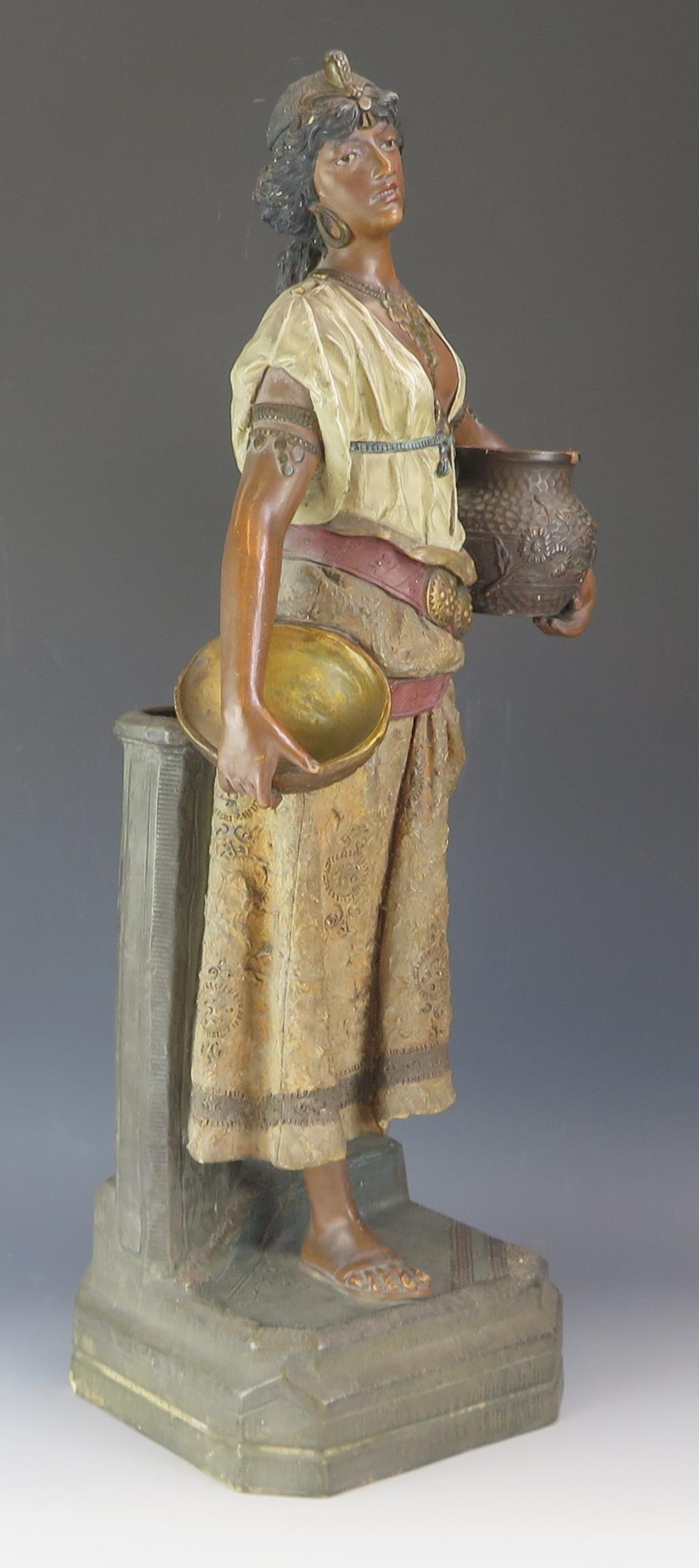 A late 19th century terracotta figure of a Nubian female water bearer, with polychrome decoration, - Image 2 of 2