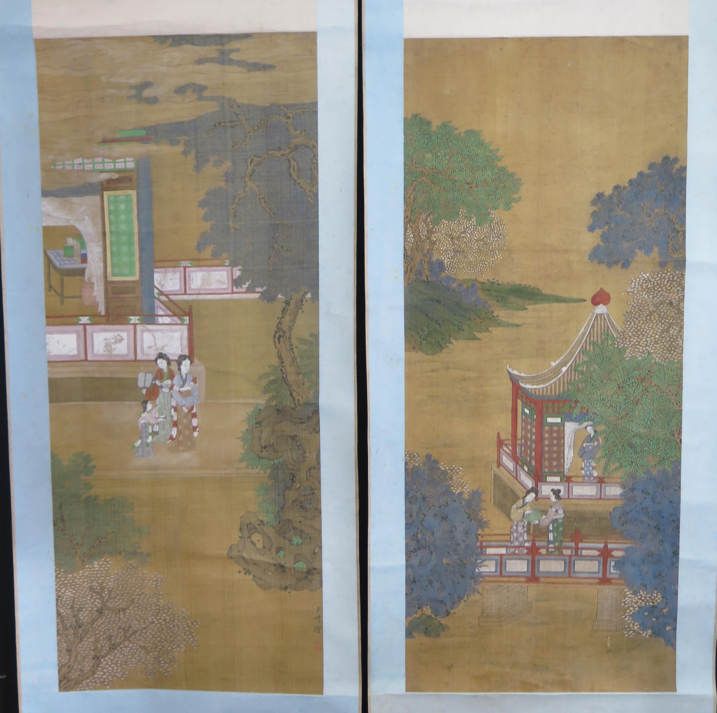 A pair of late 19th century Chinese scroll work pictures, depicting figures in a pagoda landscape,