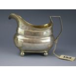 A George III silver cream jug, makers mark worn, London, 1809, of barge -shaped outline, with reeded