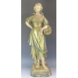 A large late 19th century French terracotta figure of a female fish seller, wearing a head scarf and