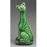A Torquay pottery 'Winks' cat, with green glaze, impressed to the base 'Winks', 12cm high.