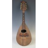A continental eight string mandolin with inlaid tortoiseshell decoration, overall length 61cm.