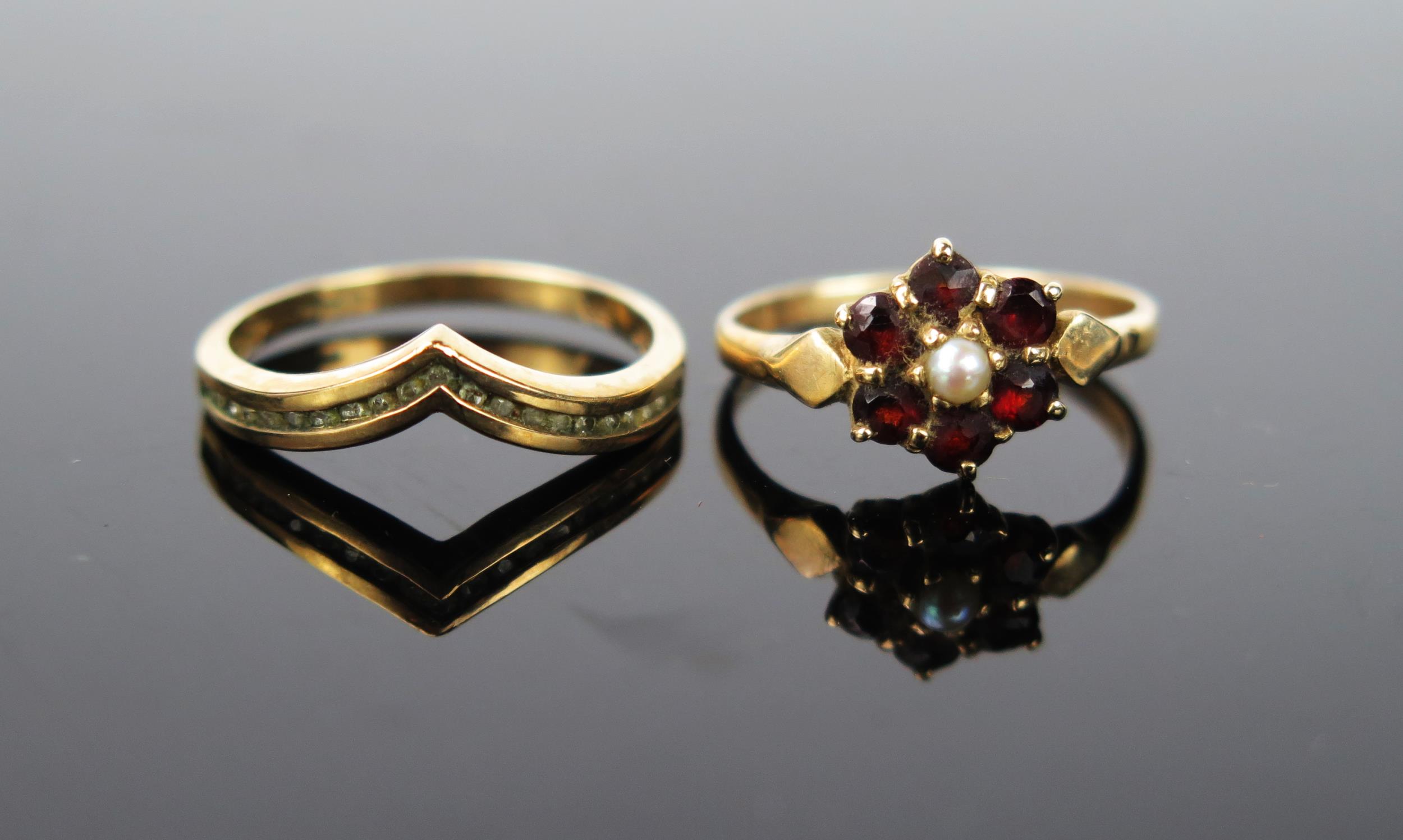 Two 9ct gold rings one with flower head of garnet with split pear, size K.5,the other with diamond
