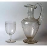 An Edwardian clear glass and etched ewer, of ovoid form with swept handle, 28cm high, together