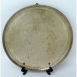14" Silver Salver with beaded and foliate rim standing on three ball and claw feet, Sheffield