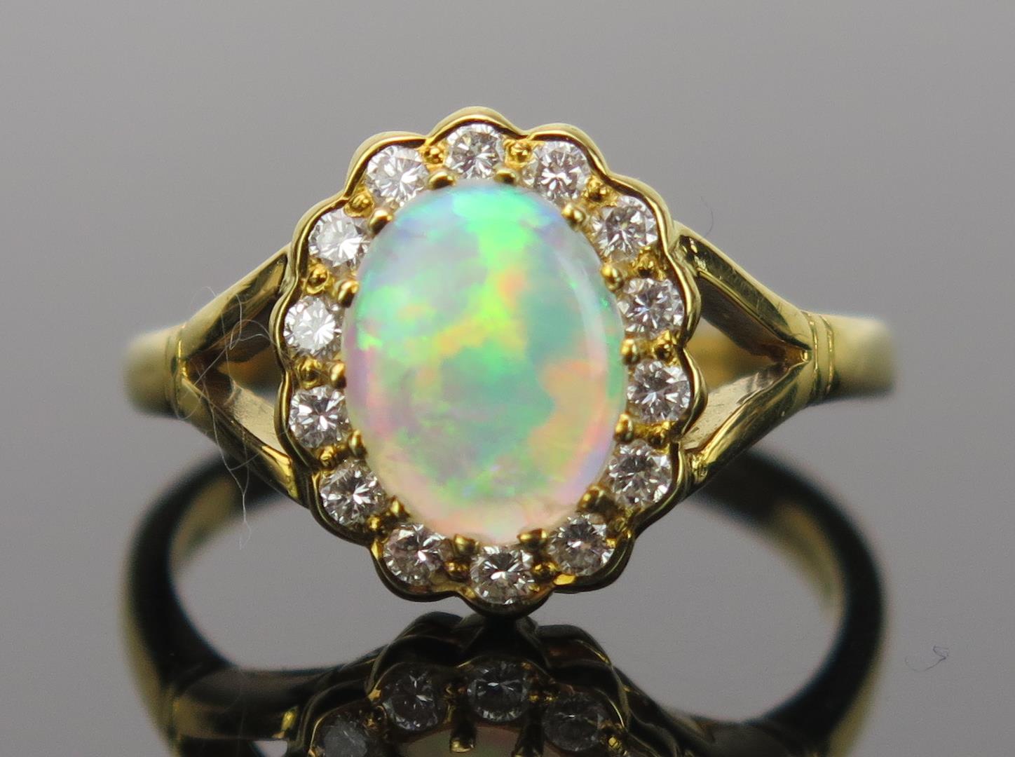 White Opal and Diamond Cluster Ring in an 18ct hallmarked gold setting, 9x7mm central stone, 13x11mm - Image 5 of 5