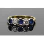 Sapphire and Diamond Five Stone Ring in an 18ct hallmarked rub over setting, c. 3.8mm stones, 19mm