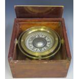 A silvered compass with 9.5 dial mounted in a brass gimbal and wood box, 19.5cm wide
