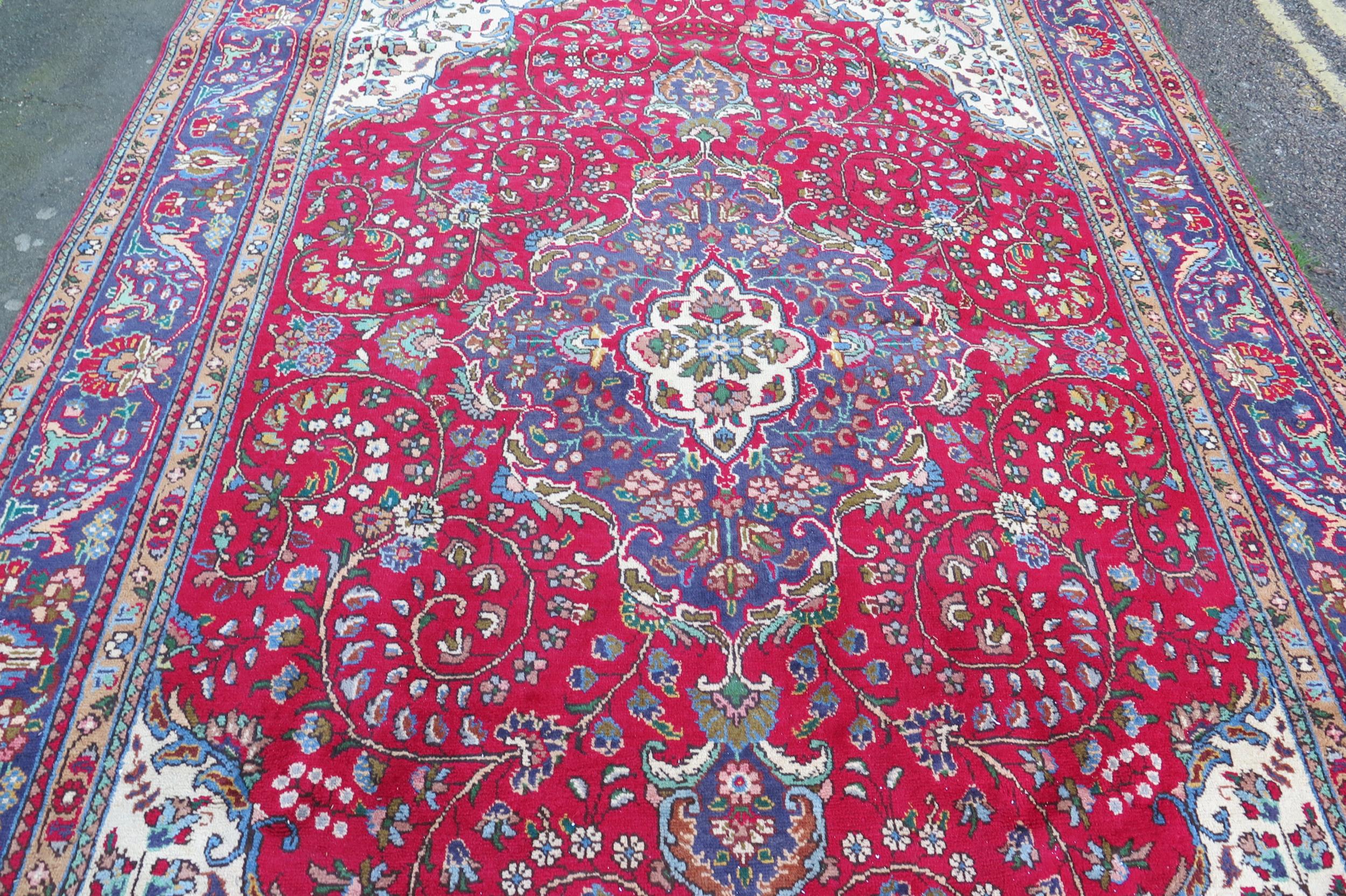 A 20th Century Kashan style wool carpet, blue central medallion, red field, cream spandrels, blue - Image 4 of 6
