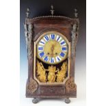 A 19th century French mantel clock, of rectangular outline, decorated with caryatids and flaming urn