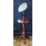 A Victorian mahogany shaving stand, with circular mirror plate, the circular platform with two