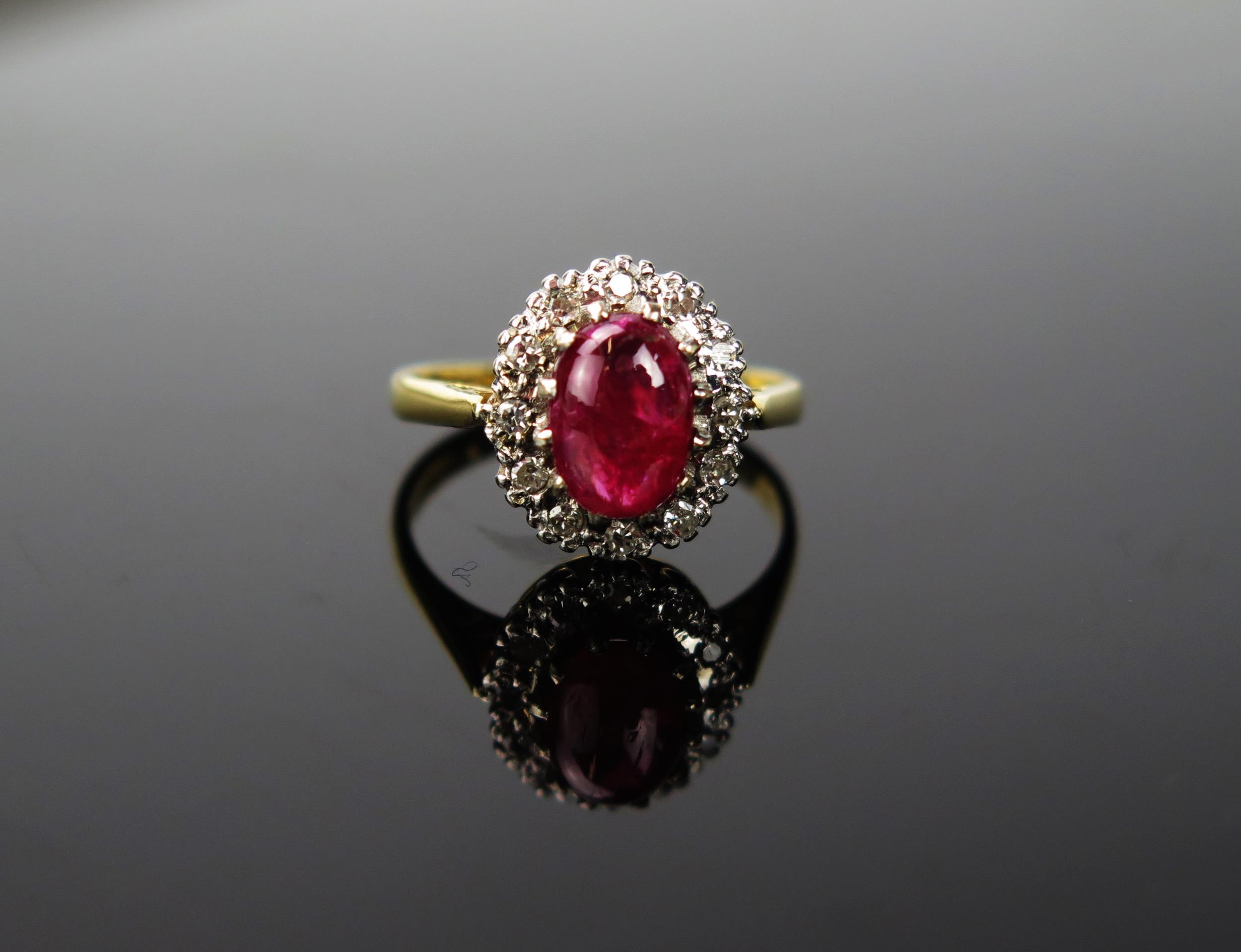 A Red Stone and Diamond chip 18ct gold ring, the cabochon stone approximately 6cm long, stamped 750,
