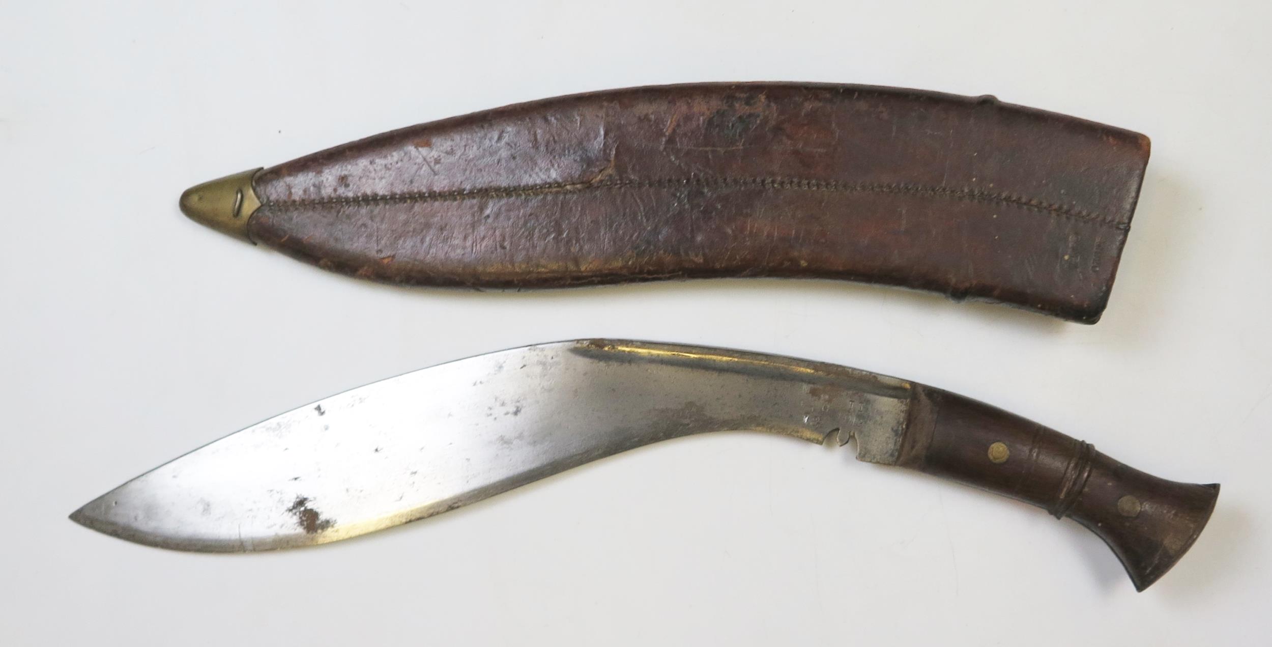 A British War Department issue kukri, with 35cm curved blade, stamped marks for 1919, contained in a