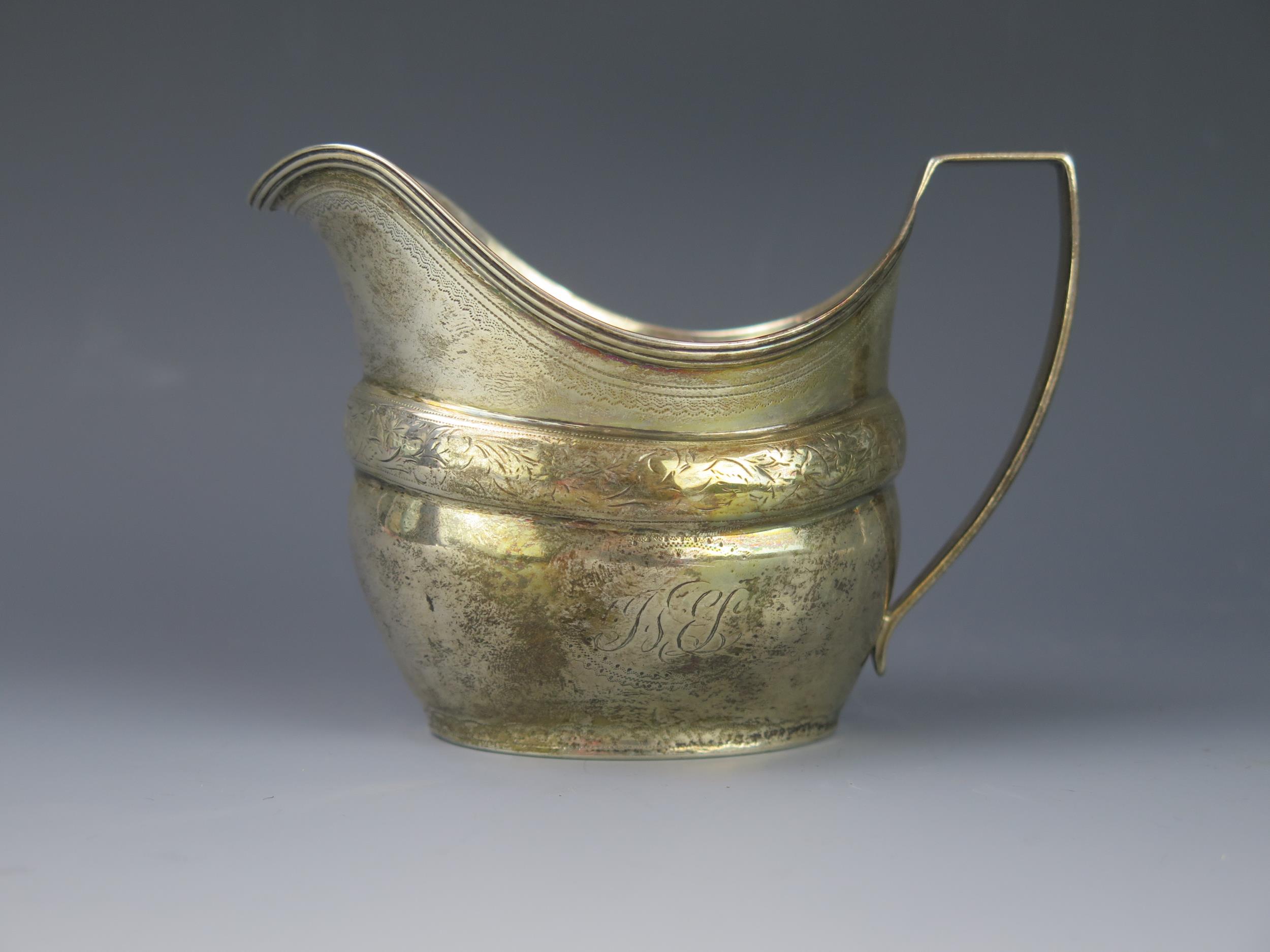 A George III silver cream jug, maker's mark worn, London, 1805, initialled, of barge-shaped outline,