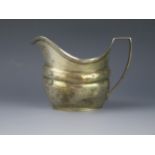 A George III silver cream jug, maker's mark worn, London, 1805, initialled, of barge-shaped outline,