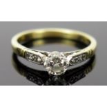 Diamond Solitaire Ring in a platinum setting with two chip diamonds to each shoulder, EDW .5ct, size