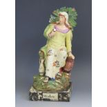 A Staffordshire pottery pearlware figure 'Widow' 26cm high. Chips to the foliage and loss of