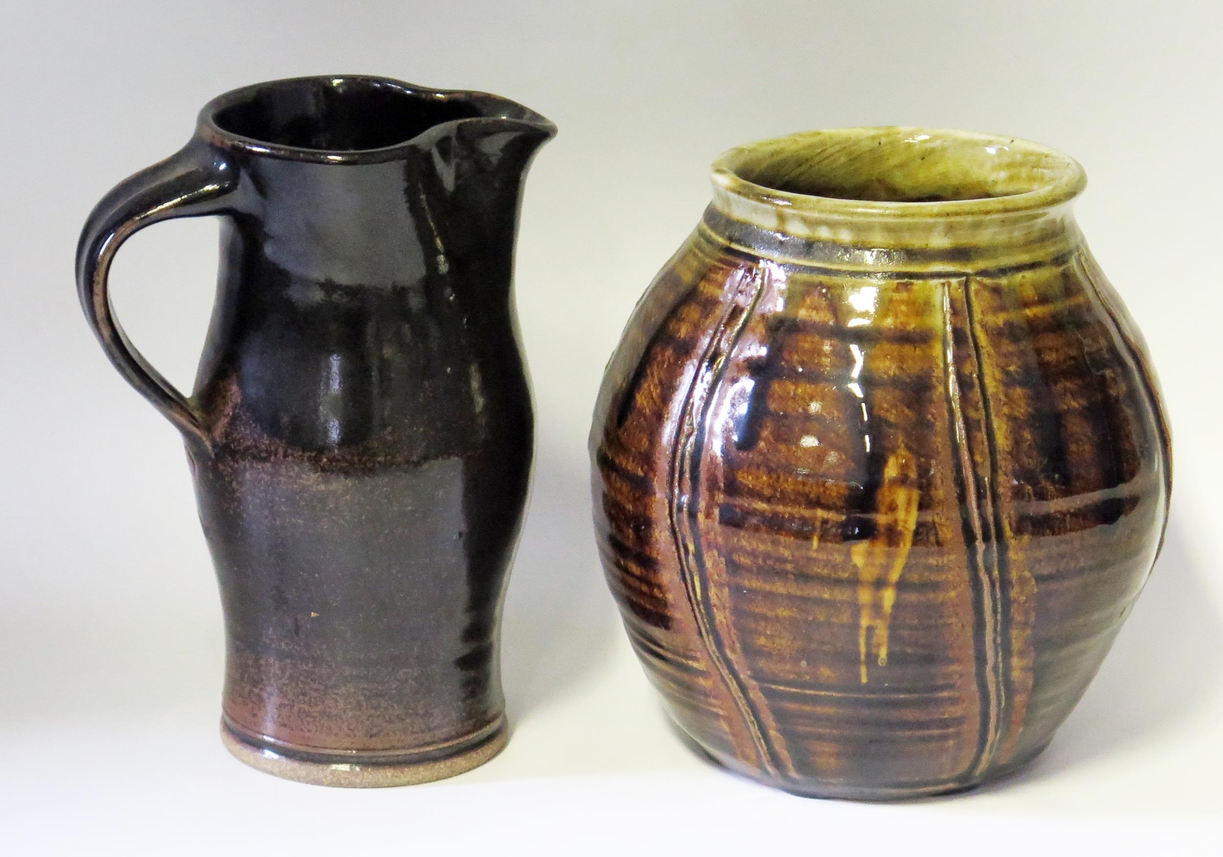 A Keith Smith (born 1946),Studio Pottery, brown glazed jug, 20cm high, together with a ribbed jar/