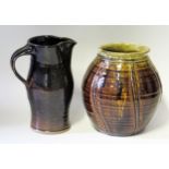 A Keith Smith (born 1946),Studio Pottery, brown glazed jug, 20cm high, together with a ribbed jar/