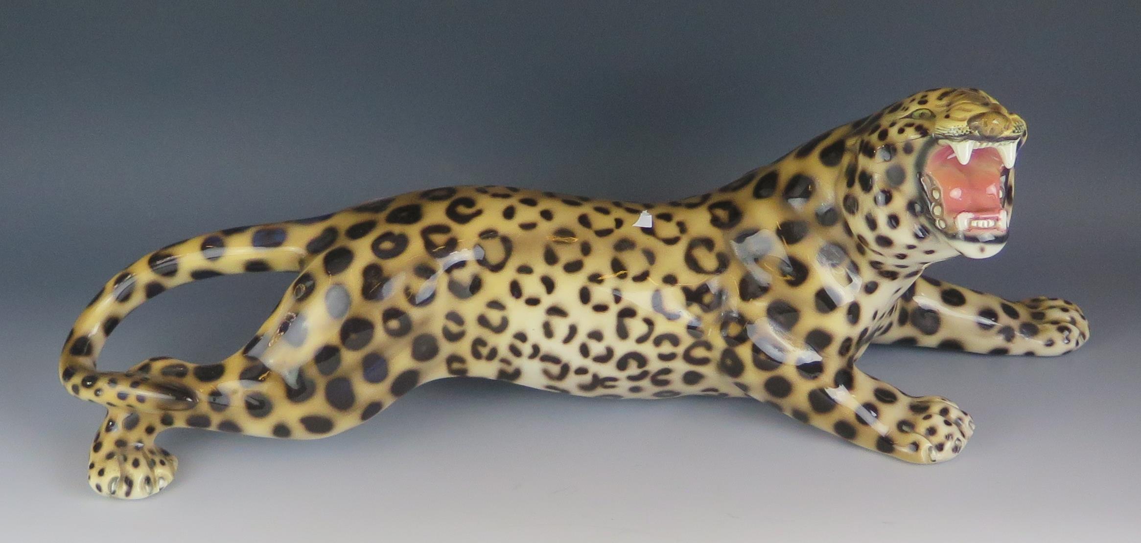 A large 20th Century Italian pottery prowling leopard, painted mark 1630/1, 63cm long.