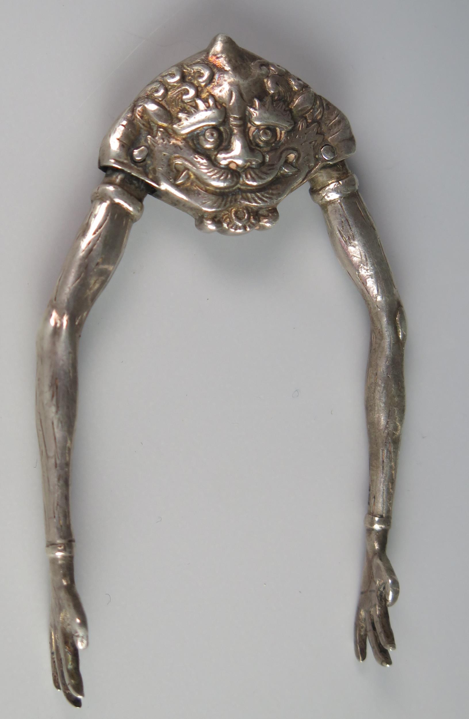 A George V silver novelty pair of sugar tongs, maker Berthold Muller, London, 1915, with grotesque