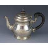 A George V silver teapot, maker Wakely & Wheeler, London, 1911, of squat ovoid form with acanthus