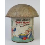 A Lucie Atwell's Fairy House Biscuit & Money Box, in the form of a mushroom, with lithographed