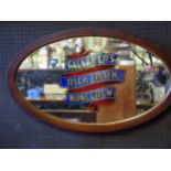 An oval advertising mirror 'Gallaher's Rich Dark Honeydew' contained in a mahogany frame 76cm wide.