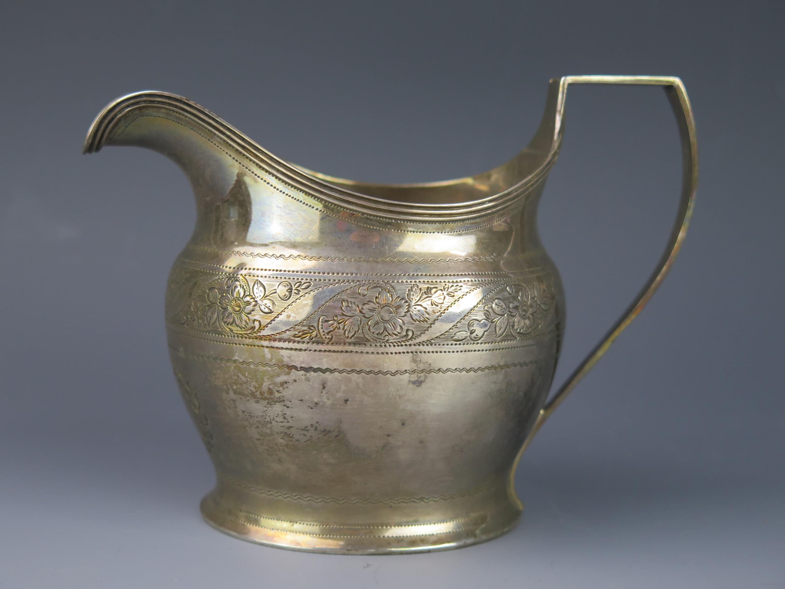 A George III silver cream jug, maker Alexander Field, London, 1801, monogrammed, of barge-shaped