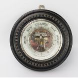 A wall mounted aneroid barometer, of circular outline contained in a mahogany frame, 23cm diameter.