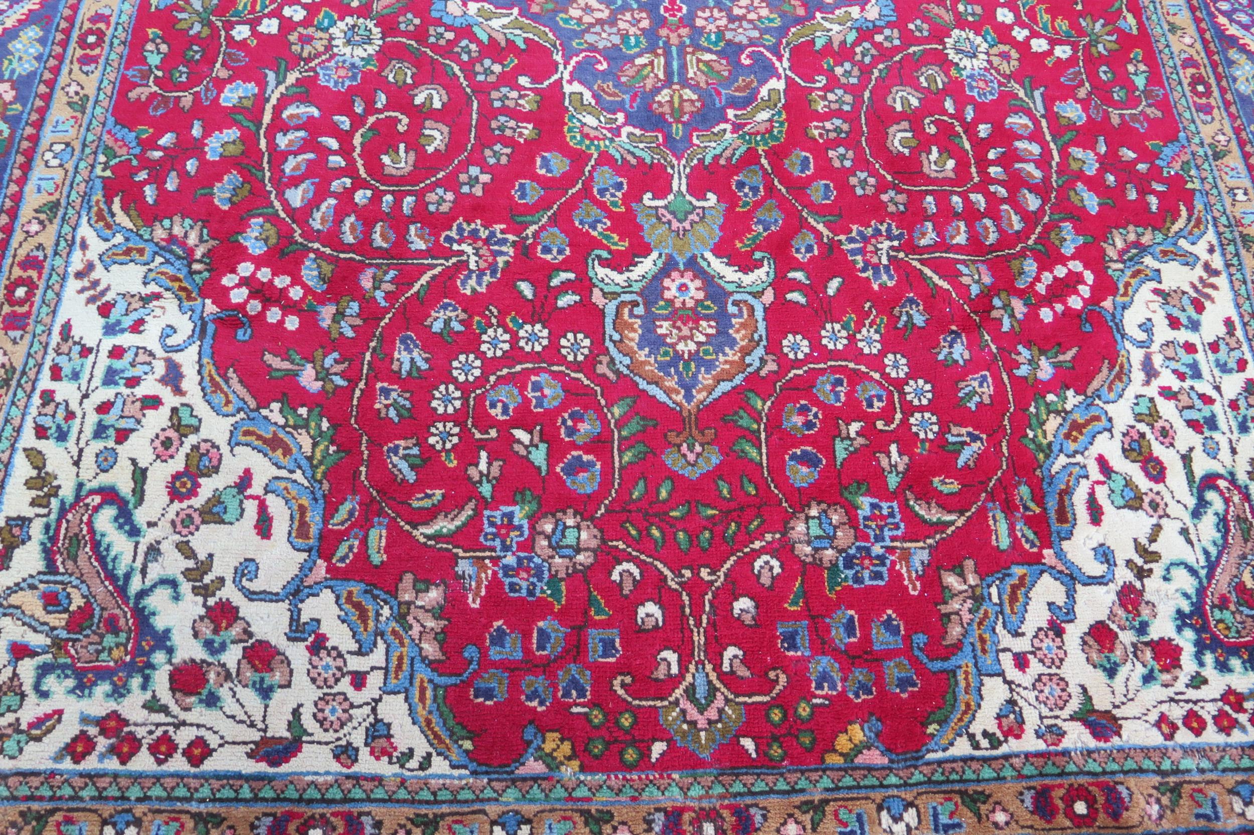 A 20th Century Kashan style wool carpet, blue central medallion, red field, cream spandrels, blue - Image 3 of 6
