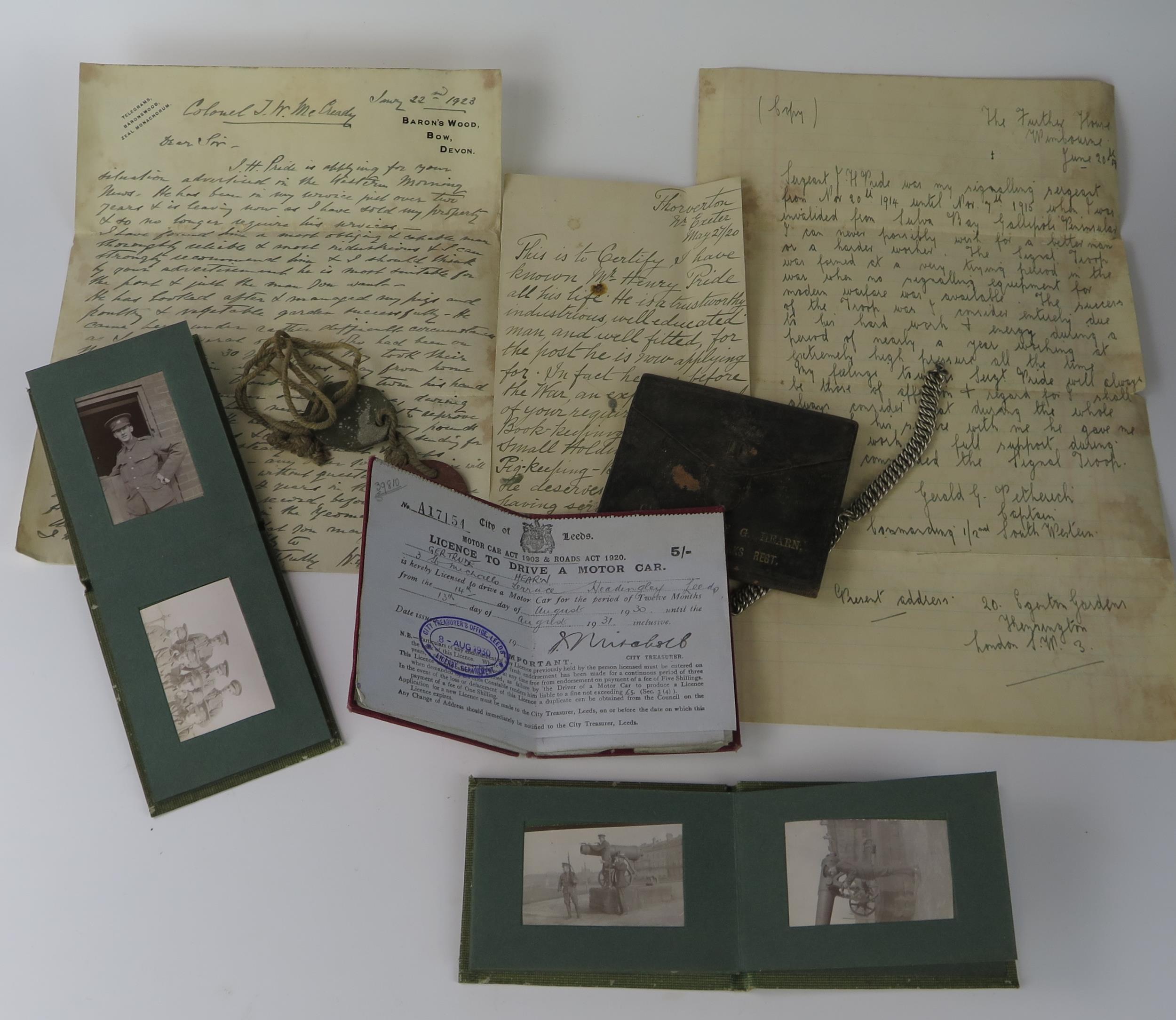 A small collection of military ephemera, including photographs, identity tags, driving licence