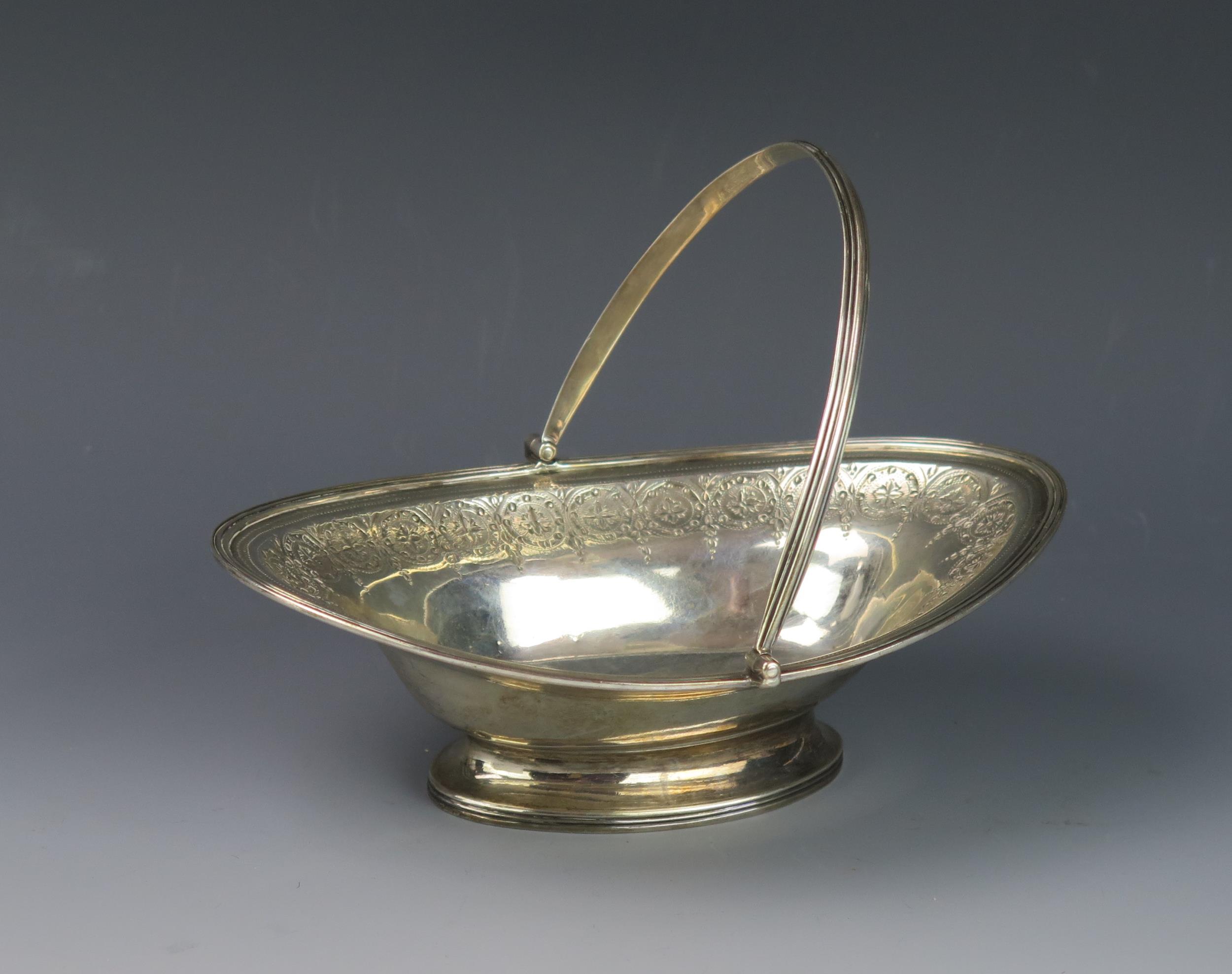 A George III silver swing handled sweetmeat dish, maker Henry Chawner, London, 1791, monogrammed, of