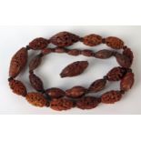 Late 19th Century Chinese Carved Nut Bead necklace, 24 beads, including Hediao nut, together with