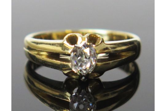 An 18ct Gold and Diamond Solitaire Ring, the oval c. 5.1x4.2mm old cut stone kin a claw setting, - Image 1 of 2