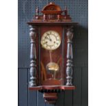 A Vienna style regulator wall clock the case with arched pediment, turned columns and glazed door,