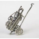 A continental silver model of a miniature golf bag and trolley, bears import marks, 5.5cm long,