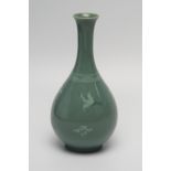 A Korean bottle vase, decorated with cranes amongst clouds to a celadon ground, bears signature to