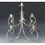 A modernist silver plated nine light dual purpose candelabra, on swept branches with urn-shaped