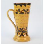 A Torquay pottery twin handled mug, inscribed with flowerhead Kerswell Daisy decoration (French